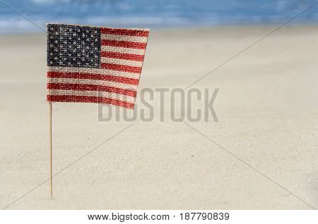 Patriotic USA background with flags and decorations on the sandy beach