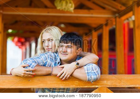 Happy loving couple. Portrait of beautiful young couple bonding to each other and smiling while both standing outdoors.