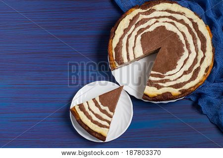 Delicious homemade chocolate cake with cottage cheese Zebra (Marble cake). Piece is cut out of the cake. Tasty breakfast. Top view