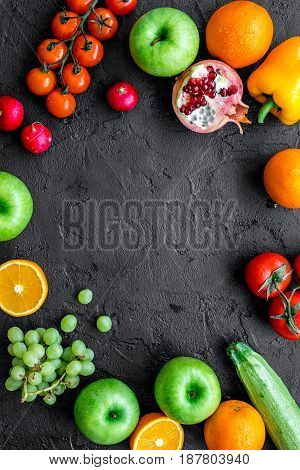 Organic fruits and vegetables for healthy dinner on darkbackground top view mock up