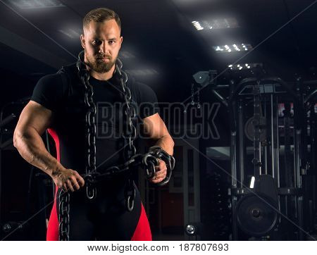A Strong Athlete Is Wearing Bench Equipment With A Chain Around His Neck