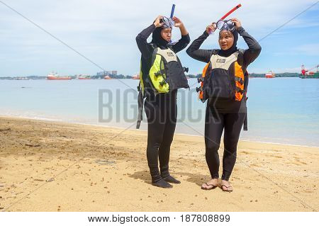 Labuan,Malaysia-Feb 19,2017:Young woman with life jacket & snorkel gear,ready to having fun doing snorkel watersport activity in Papan island of Labuan,Malaysia.