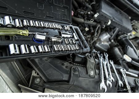 Car Mechanic Man At The Garage Fixing The Engine