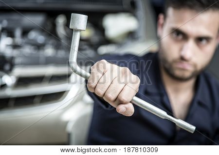 Car Mechanic Man At The Garage Fixing The Engine