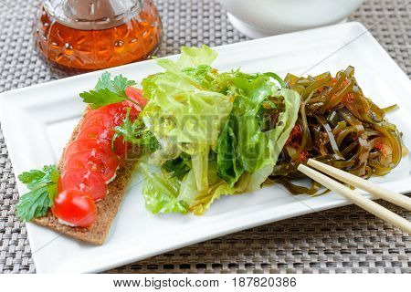 Asian dietic salad with Laminaria served on white dish