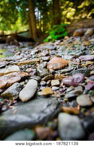 Colorful stones stacked along the shore edge in Glacier National Park Montana