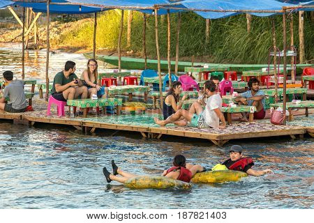 Vang Vieng, Laos - January 19, 2017: Tourist enjoy tubing in Song River at Vang Viang, Laos.