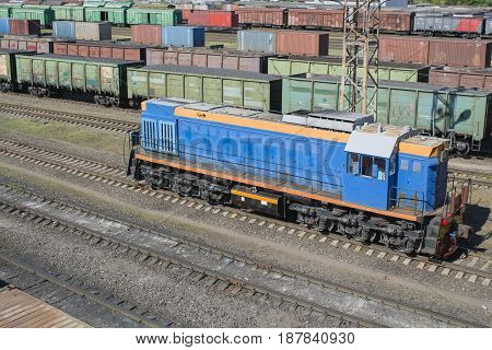Bright locomotive against the background of a large number of wagons