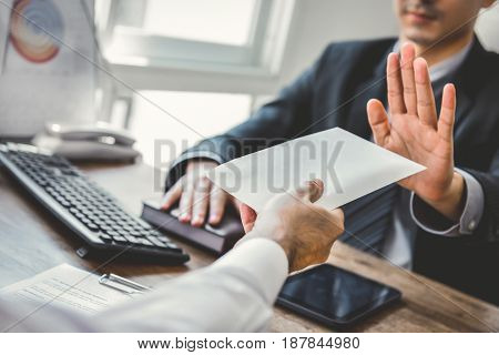 Businessman refusing money in the envelope - anti bribery and corruption concepts