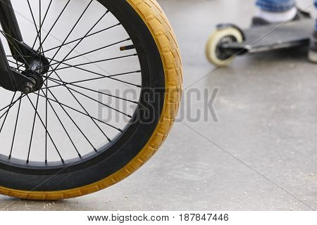 Bike wheel detail and skate. Sport background. Horizontal