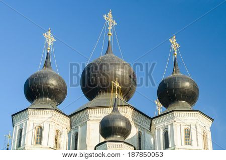 Russian Orthodox church with dark domes on sunny day