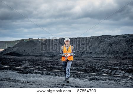 coal mining worker walking through open pit