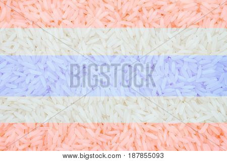 Closeup pile of white rice called jasmine rice signature of thailand with thailand flag sign textured background