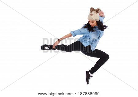 teenager in jeans dancing street dance on white
