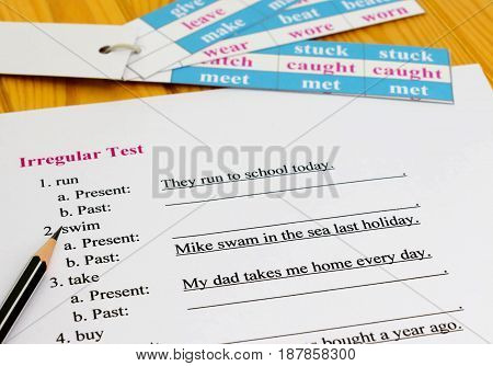 English test on table with pencil and cards