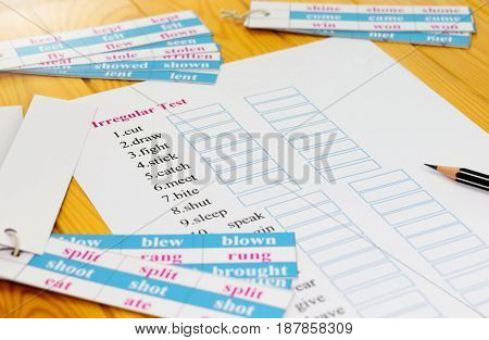 English test on table with pencil and cards
