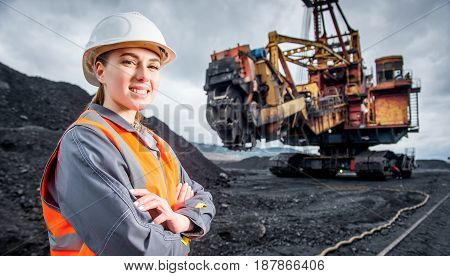 coal mining worker with excavator on the background