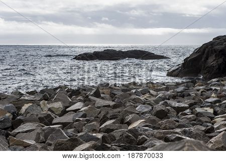 Stony Seashore Alongside Lofoten Islands in Norway During Sunset Hour. Horizontal Image Orientation