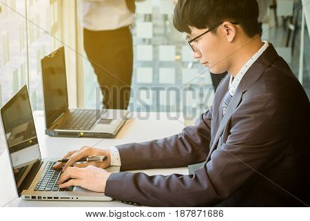 business man working document and laptop in office morning light. business concept.
