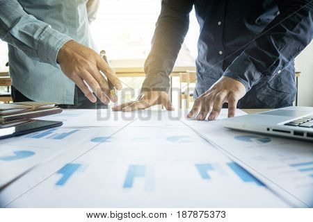 Business team two colleagues discussing working with many document graph in team Meeting Talking Brainstorming Communication Concept.