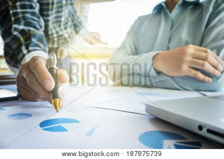 young coworkers crew working with new startup project in modern loft analyze plans on desk. business concept.