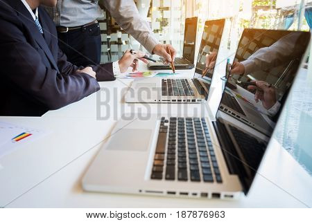 Two businessmen looking at report and having a discussion in office. business concept.