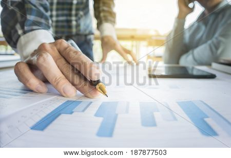 Two businessmen looking at report and having a discussion in office. business concept.