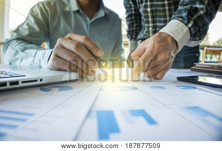 Two businessmen looking at report and having a discussion in office. business concept.