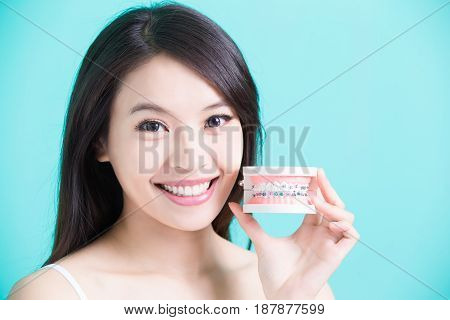 woman with bace tooth model on the green background
