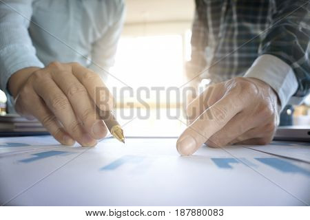 Two businessmen looking at report and having a discussion in office. business concept.
