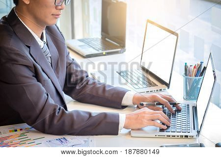 business man working document and laptop in office morning light. business concept.