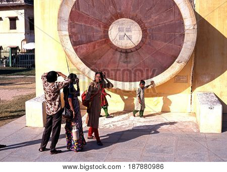 JAIPUR, INDIA - NOVEMBER 24, 1993 - People looking at the giant sundial known as the Samrat Yantra at Jantar Mantar Jai Singhs Observatory Jaipur Rajasthan India, November 24, 1993.
