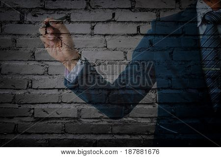 double exposure of businessman in suit pointing cement wall.