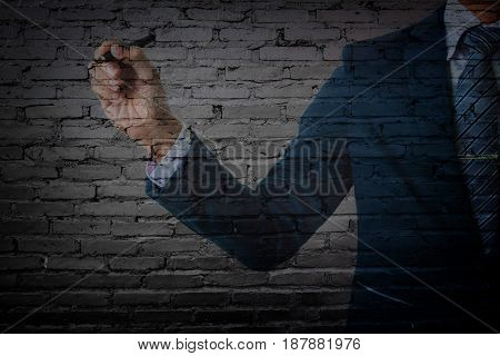 double exposure of businessman in suit pointing old black cement wall.