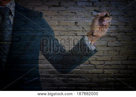 double exposure of businessman in suit pointing old black cement wall.