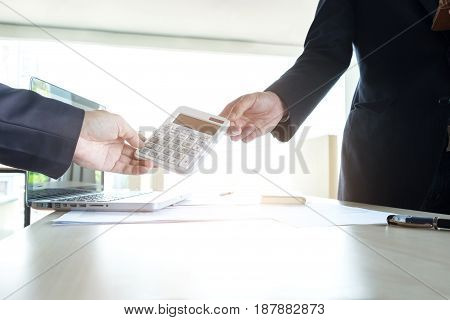 businessman send calculator to manager for estimation working invesment concept.