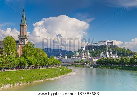 Classic postcard view of the historic city of Salzburg with famous Festung Hohensalzburg reflecting in beautiful Salzach river in summer Salzburger Land Austria