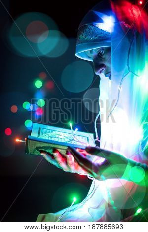 Muslim man praying for god in dark room at ramadan,colorful and vintage tone filter effect color style