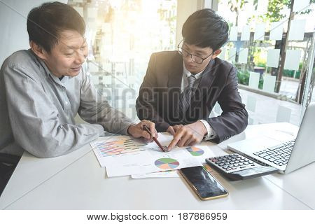 Business team two colleagues discussing working with many document graph in team Meeting Talking Brainstorming Communication Concept.