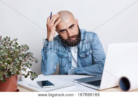 People, Career, Business And Success Concept. A Portrait Of Young Uccessful Bearded Bald Businessman