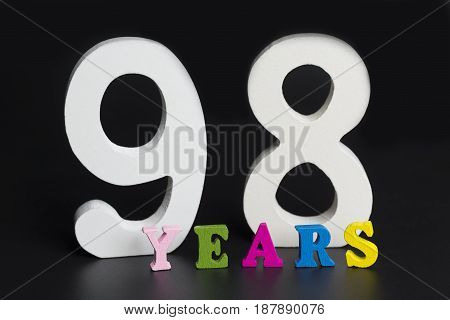 Letters And Numbers Ninety-eight Years Old On A Black Background.