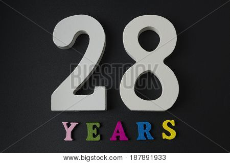 Letters And Numbers Twenty-eight Years On A Black Background.