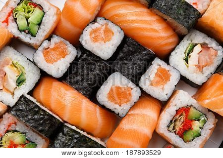 Sushi and rolls pattern background, japanese restaurant delivery top view. Salmon, unagi, california and other healthy meals