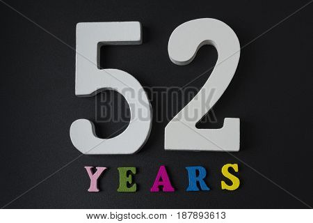 Letters And Numbers-fifty-two On A Black Background.