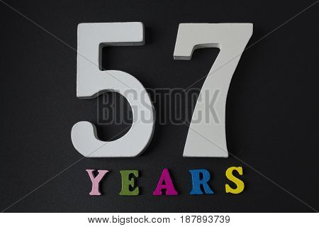 Letters And Numbers-fifty-seven On A Black Background.
