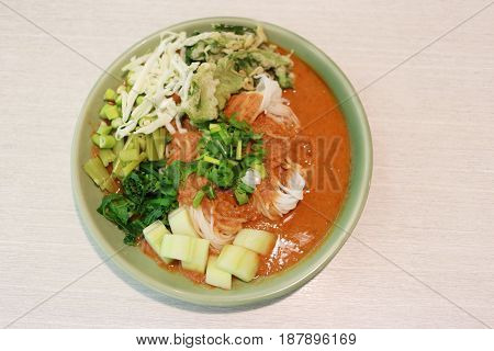 Thai Noodles (Kanom jeen) in a green dish on a food table.