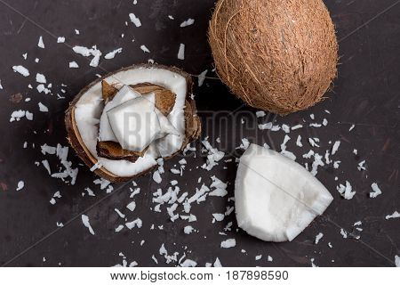 Top View Of Pieces Of Ripe Tropical Coconut On Dark Background, Coconut Shavings