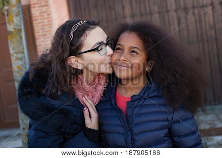Two happy girls friends lauging outside