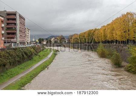 The view at embankment of Bisenzio River in a cloudy day. Prato. Tuscany. Italy.