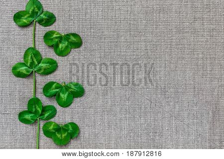 Green Leaves Of Clover On The Background Of Linen Cloth.